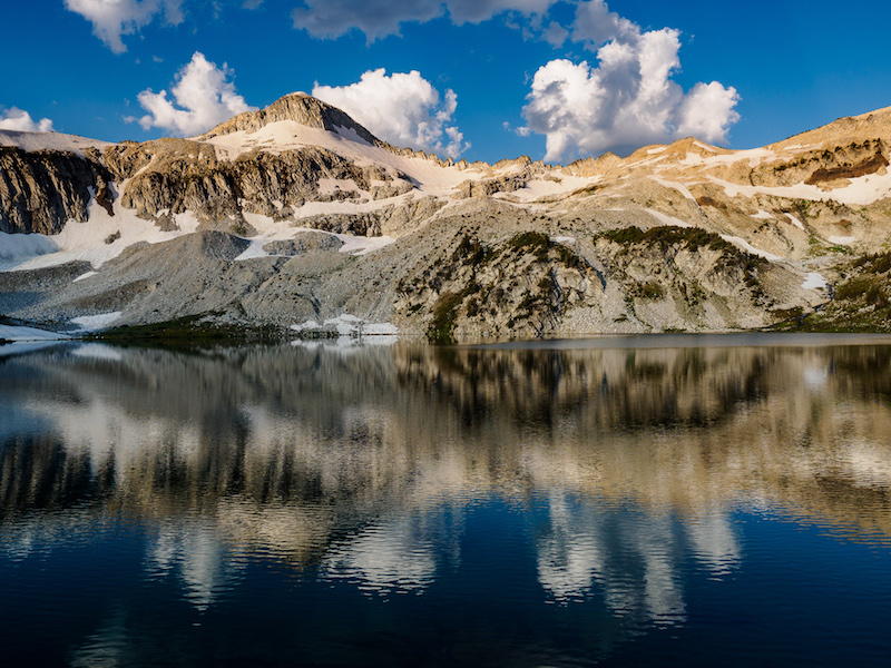 Glacier Peak and clouds reflecting on Glacier Lake.